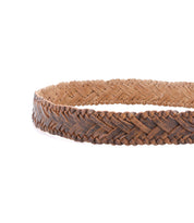 A close-up of the Bed|Stü Proem belt, featuring handwoven artisan craftsmanship in a braided leather pattern with rich brown and tan hues, finished with a vintage metal buckle, set against a white background.