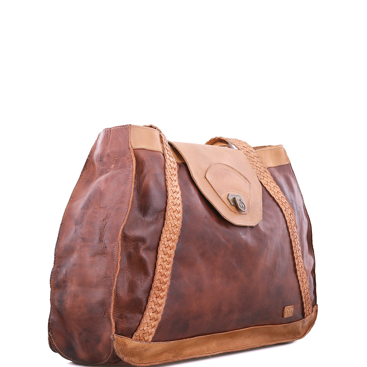 The Proper tote bag by Bed|Stü is crafted from brown vegetable-tanned leather with braided accents and handwoven straps, featuring a tan flap closure, visible stitching, and an interior lined with organic cotton. It is displayed against a white background.