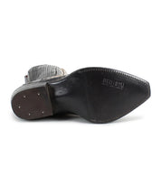 A low-angle view of the "Raise" black leather shoe by Bed Stu reveals its visible sole details and embossed brand name, echoing the rugged charm of a Western boot with its sleek design.