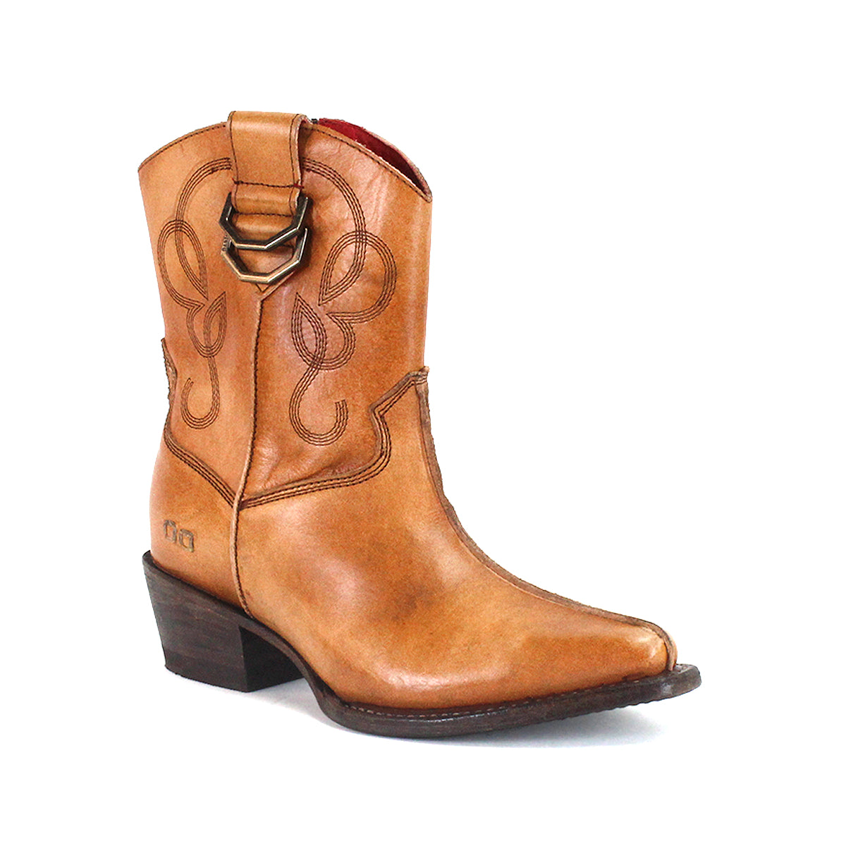 The Bed|Stü Rangeley is a tan leather cowboy boot adorned with decorative stitching and lines, featuring a side pull strap, low angled heel, and pointed toe for a distinctive look, shown against a white background.