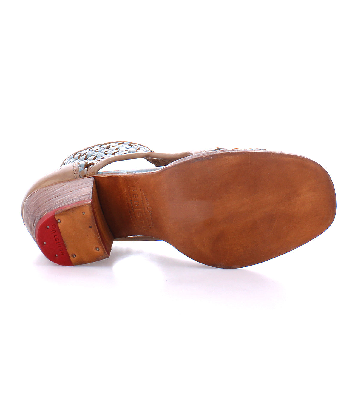 A single leather sandal with a decorative strap viewed from the sole side up, showcasing Bed Stu artisan craftsmanship.
