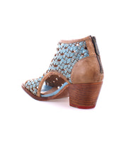 Blue and brown woven vegetable tanned leather Ransom heel sandal by Bed Stu against a white background.