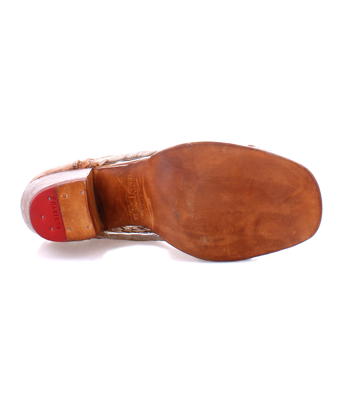 Leather shoe sole with a visible Bed Stu stamp and a hint of red on the heel, showcasing artisan craftsmanship.