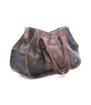 A distressed brown leather heritage-inspired handbag with two handles, featuring visible stitching and the "Bed Stu" brand embossed on the front—meet Redrock, your ideal everyday carry.