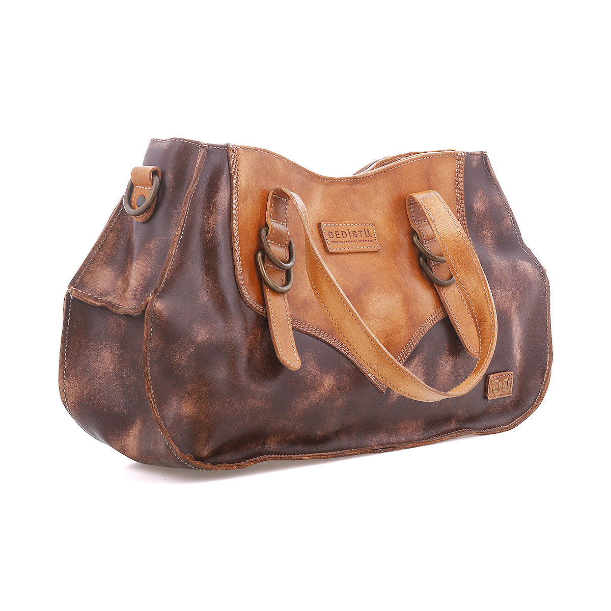 Inspired by heritage style, the Redrock by Bed Stu is a brown and tan leather handbag with double handles, side buckles, and a logo patch—ideal for everyday use.