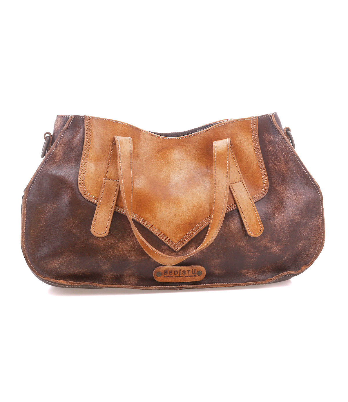 The Bed Stu Redrock is a brown and tan leather handbag with dual handles, a curved flap design, and a front logo patch—heritage-inspired style ideal for everyday use.