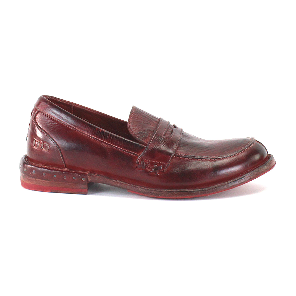 The Reina penny loafer by Bed|Stü is displayed in profile on a white background, showcasing a brown leather upper with visible stitching and a slightly worn sole.
