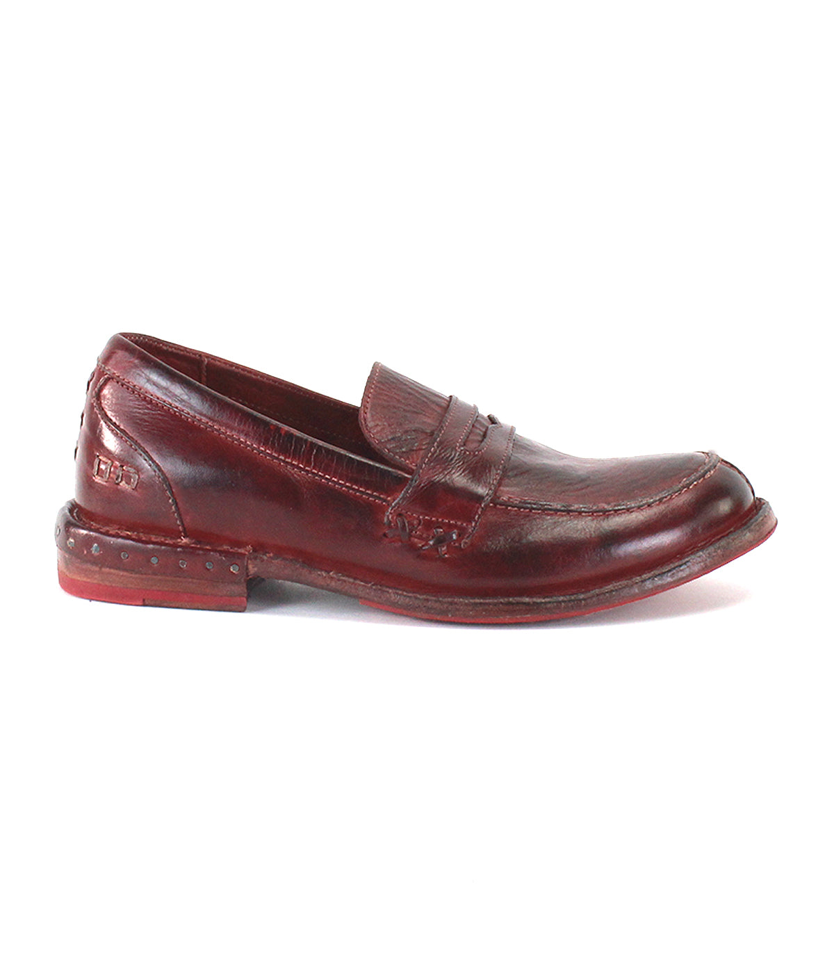 The Reina penny loafer by Bed|Stü is displayed in profile on a white background, showcasing a brown leather upper with visible stitching and a slightly worn sole.
