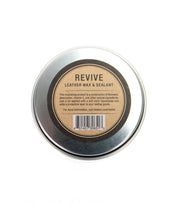 Top view of a closed tin of Bed|Stü Revive Leather Care Package on a white background.
