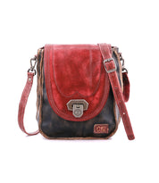 The Bed Stu Rhyme is a compact crossbody with a distressed black body, red flap, brown strap, and metal clasp—an ideal handbag for versatile day-to-night use.