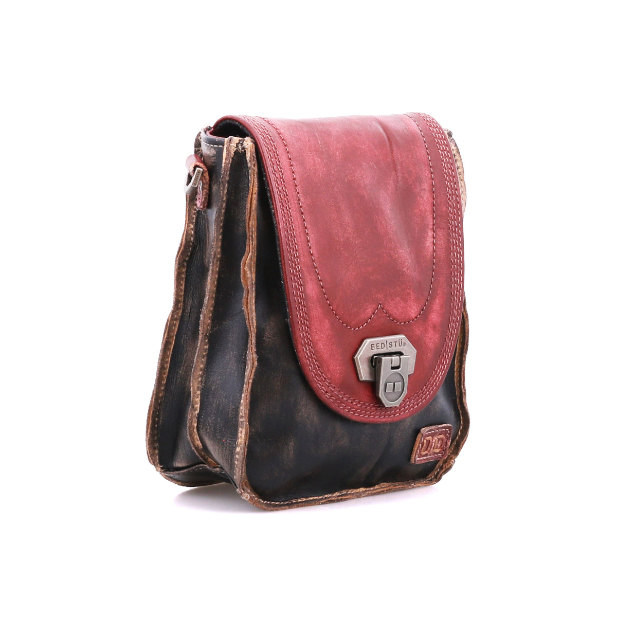 The Bed Stu Rhyme is a small, vintage-style leather satchel with a red flap, dark brown body, and metal clasp that doubles as a compact crossbody bag for hands-free convenience, shown against a white background.