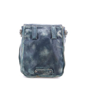 The Bed Stu Rhyme is a small, distressed blue leather crossbody bag with visible creases and a metal Rivets U label on the front, offering a stylish hands-free option. Photographed against a white background.