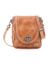 Bed|Stü Rhyme tan leather crossbody bag featuring a flap closure, antique brass hardware, and contrast stitching on this compact handbag.