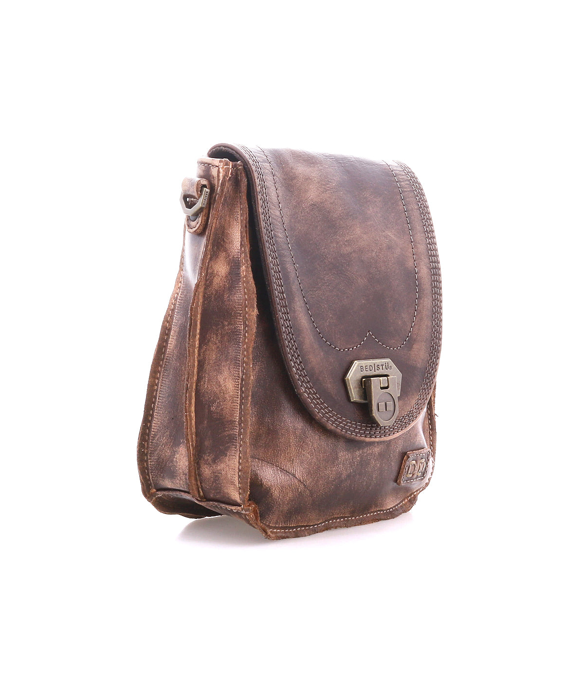 The Bed Stu Rhyme is a brown leather handbag with a distressed finish, front flap, metal clasp, and adjustable strap, shown on a white background.