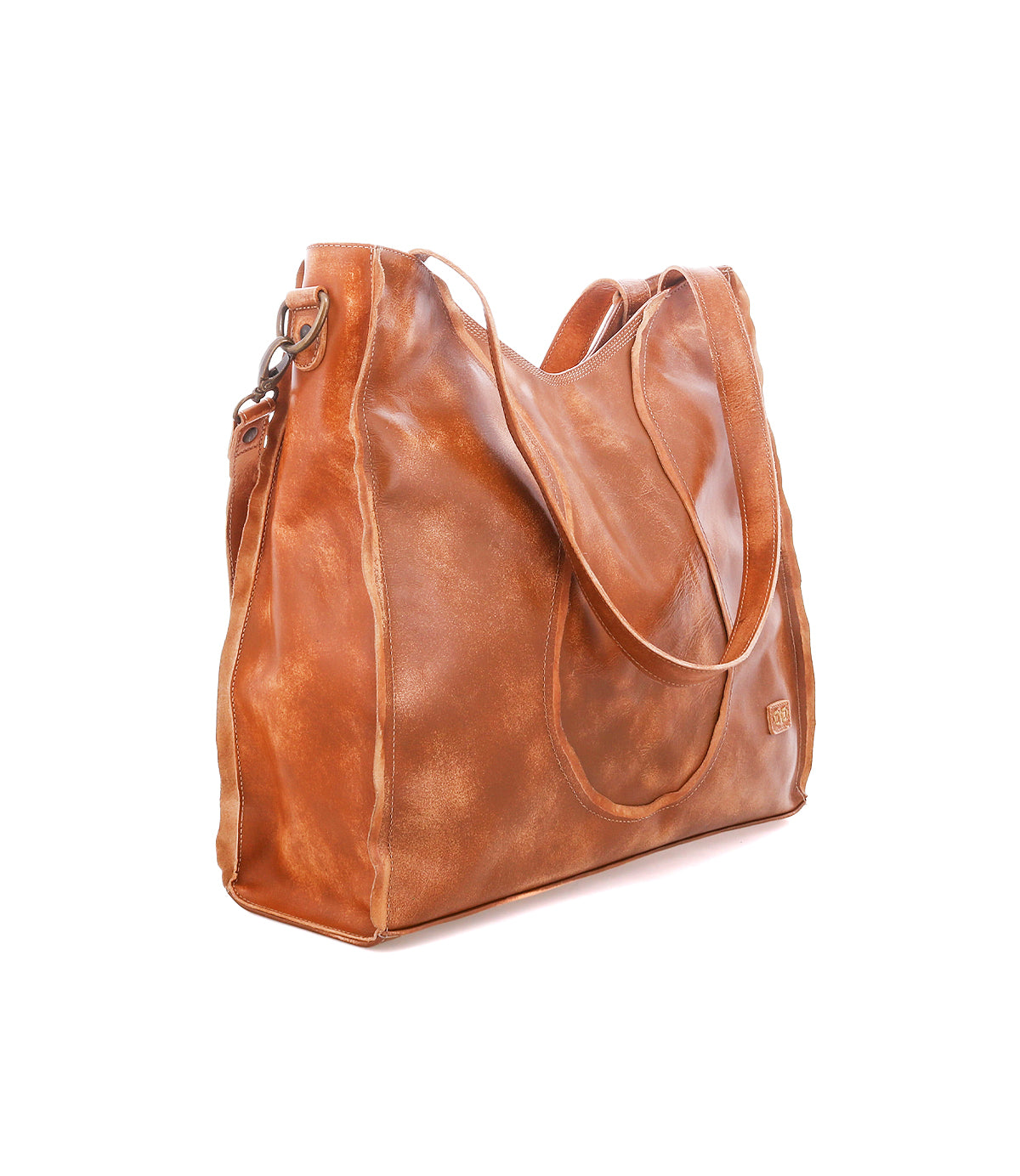 The Ridgefield tote by Bed|Stü is a large brown full-grain leather bag with dual shoulder straps and a side buckle, displayed on a white background. Designed for everyday use, this tote features an organized interior that brings together effortless style and functionality.