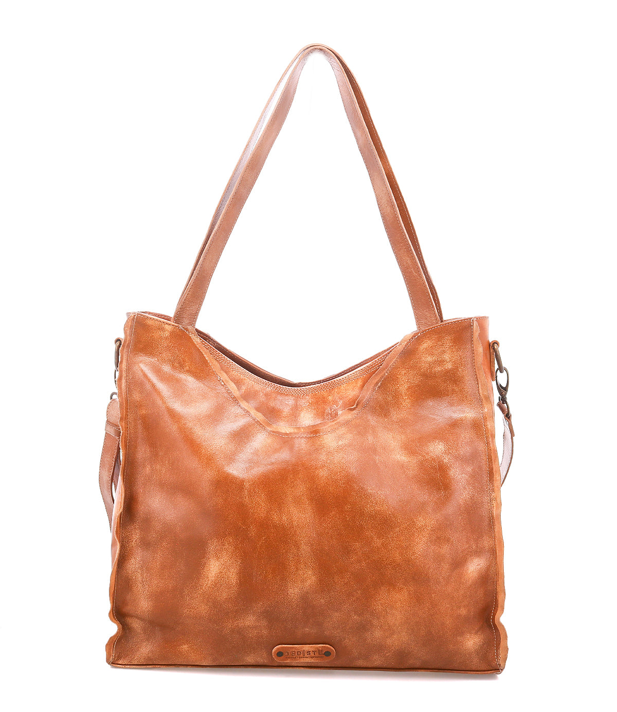 The Bed|Stü Ridgefield is a large full-grain leather tote bag with dual shoulder straps and a subtle logo on the front, featuring an organized interior for all your essentials, shown against a plain white background.