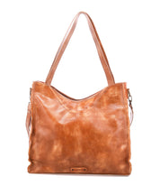 The Bed|Stü Ridgefield is a large full-grain leather tote bag with dual shoulder straps and a subtle logo on the front, featuring an organized interior for all your essentials, shown against a plain white background.