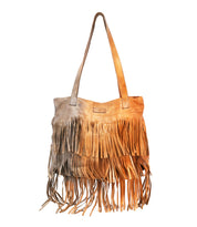 The Rimes tote by Bed Stu is a beige handcrafted leather bag with two handles, layered fringe on the front and bottom, and a spacious interior for your essentials.