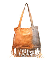 The Bed Stu Rimes is a handcrafted leather tote bag featuring long shoulder straps, fringe accents on the sides and bottom, and a spacious interior for your essentials.