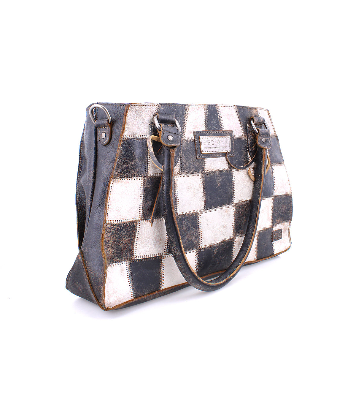 A Rockababy SL handbag with black and white squares and upcycled scrap leather trim stands against a white background, emphasizing sustainability by Bed Stu.