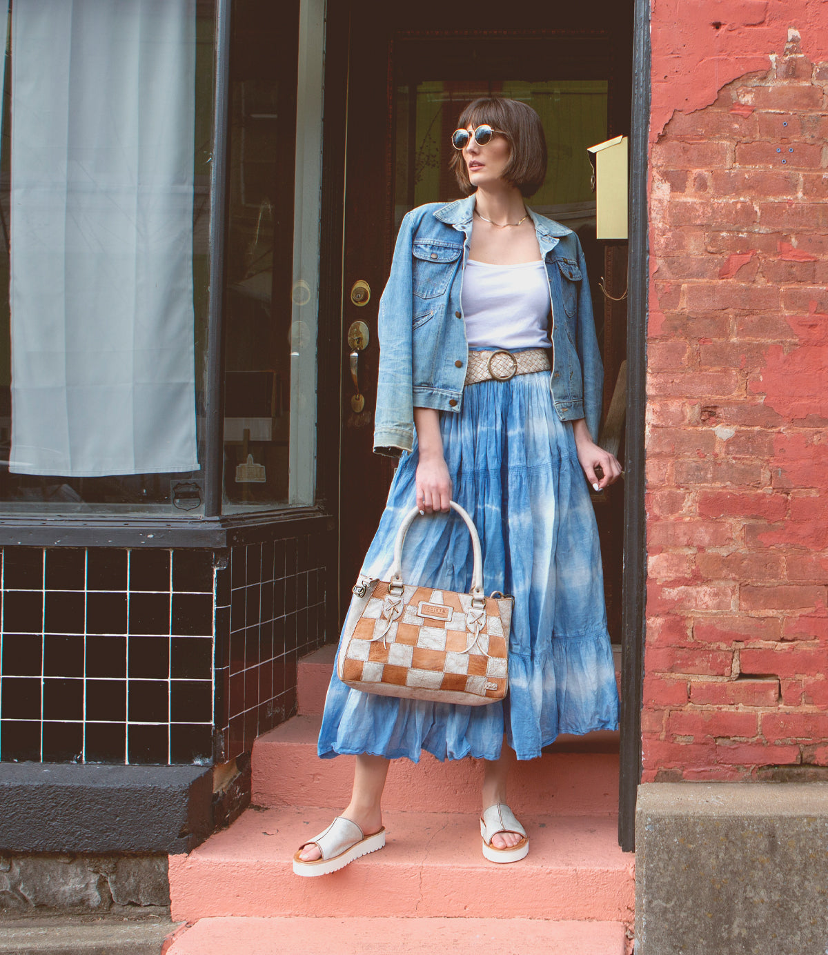 A woman wearing a Rockababy SL leather skirt and Bed Stu denim jacket, showcasing sustainability and environmentally friendly fashion.