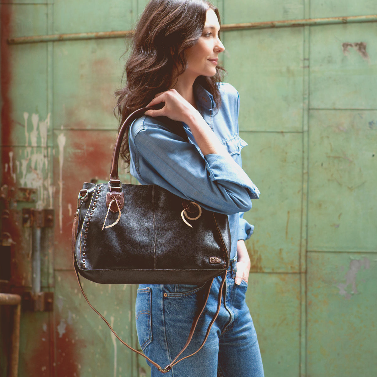 A stylish woman carrying a Bed Stu Rockababy handbag.
