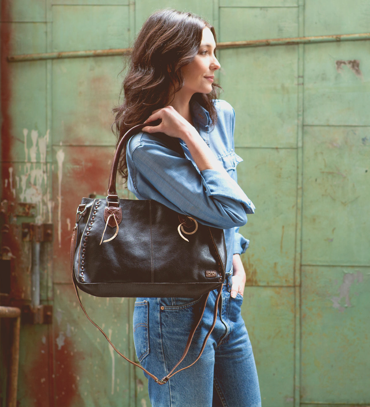 A stylish woman carrying a Bed Stu Rockababy handbag.