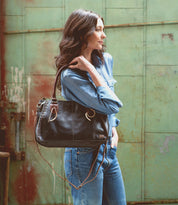 A stylish woman carrying a Bed Stu Rockababy handbag.