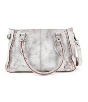 The Rockababy by Bed Stu is a silver leather handbag featuring two handles, decorative stitching, and a versatile crossbody strap.