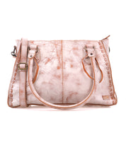 A pink leather handbag from Bed Stu with two handles, featuring a Rockababy crossbody strap and decorative stitching along the edges.