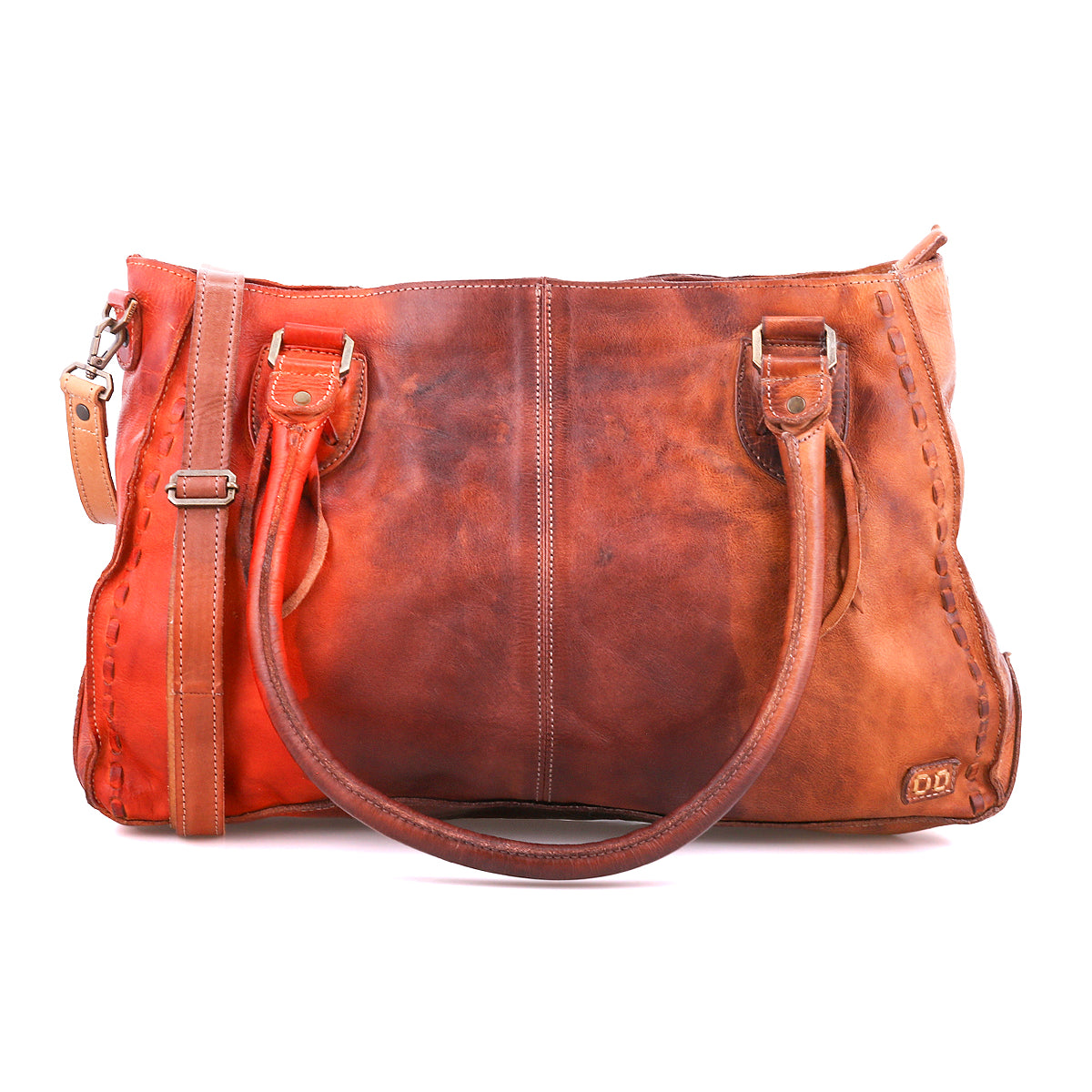 Bed|Stü’s Rockababy is a brown vegetable-tanned leather handbag featuring two handles, a detachable shoulder strap for crossbody versatility, visible stitching, and a small embossed logo on the lower right corner, all set against a white background.