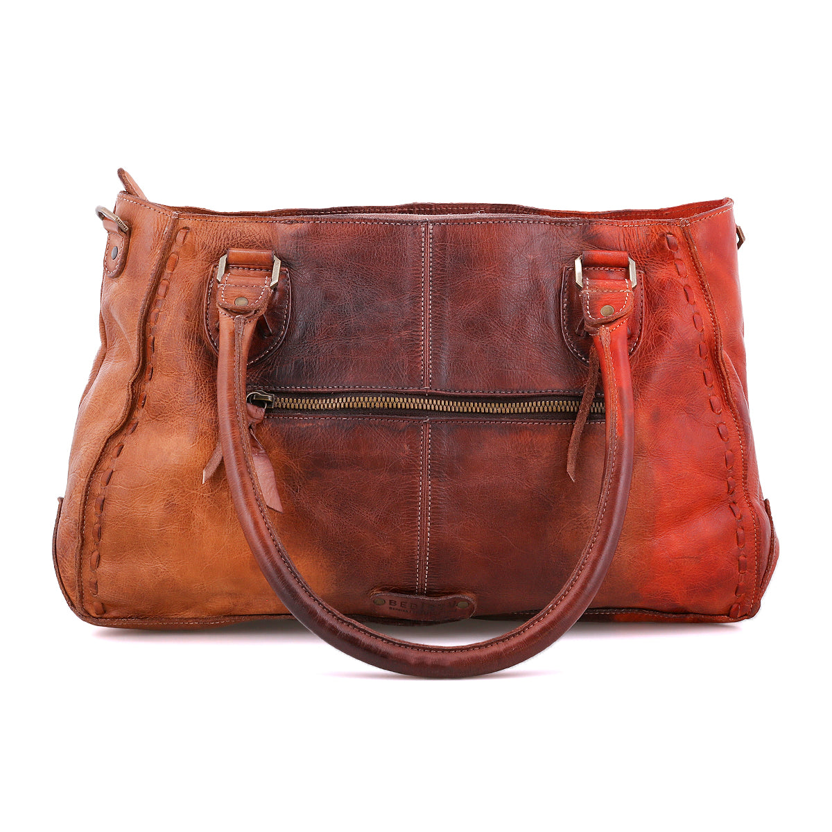 The Rockababy handbag by Bed|Stü, crafted from brown vegetable-tanned leather, features two handles, a front zipper pocket, and visible stitching along the edges. It is displayed against a white background.