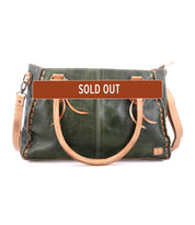 The Bed Stu Rockababy is a green and tan leather crossbody bag with two handles and a shoulder strap, marked "SOLD OUT"—a compact, everyday essential.
