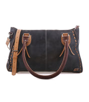 The Rockababy by Bed|Stü is a rectangular black leather handbag featuring brown handles, a tan adjustable shoulder strap, and decorative stitching along the edges—a compact leather bag designed to carry your everyday essentials in style.