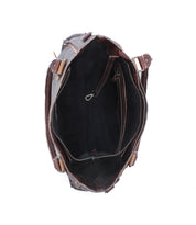 Top view of the open Bed|Stü Rockababy handbag, featuring handcrafted, rich vegetable-tanned leather with visible stitching and metal hardware; showcases a spacious main compartment, an inner zip pocket, and a smaller pouch inside.