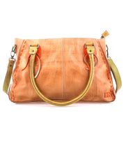 The Bed Stu Rockababy brown leather handbag features dual handles, a detachable green strap, and orange stitching accents. Its compact design includes an embossed logo on the lower corner, enhancing its sleek appeal.