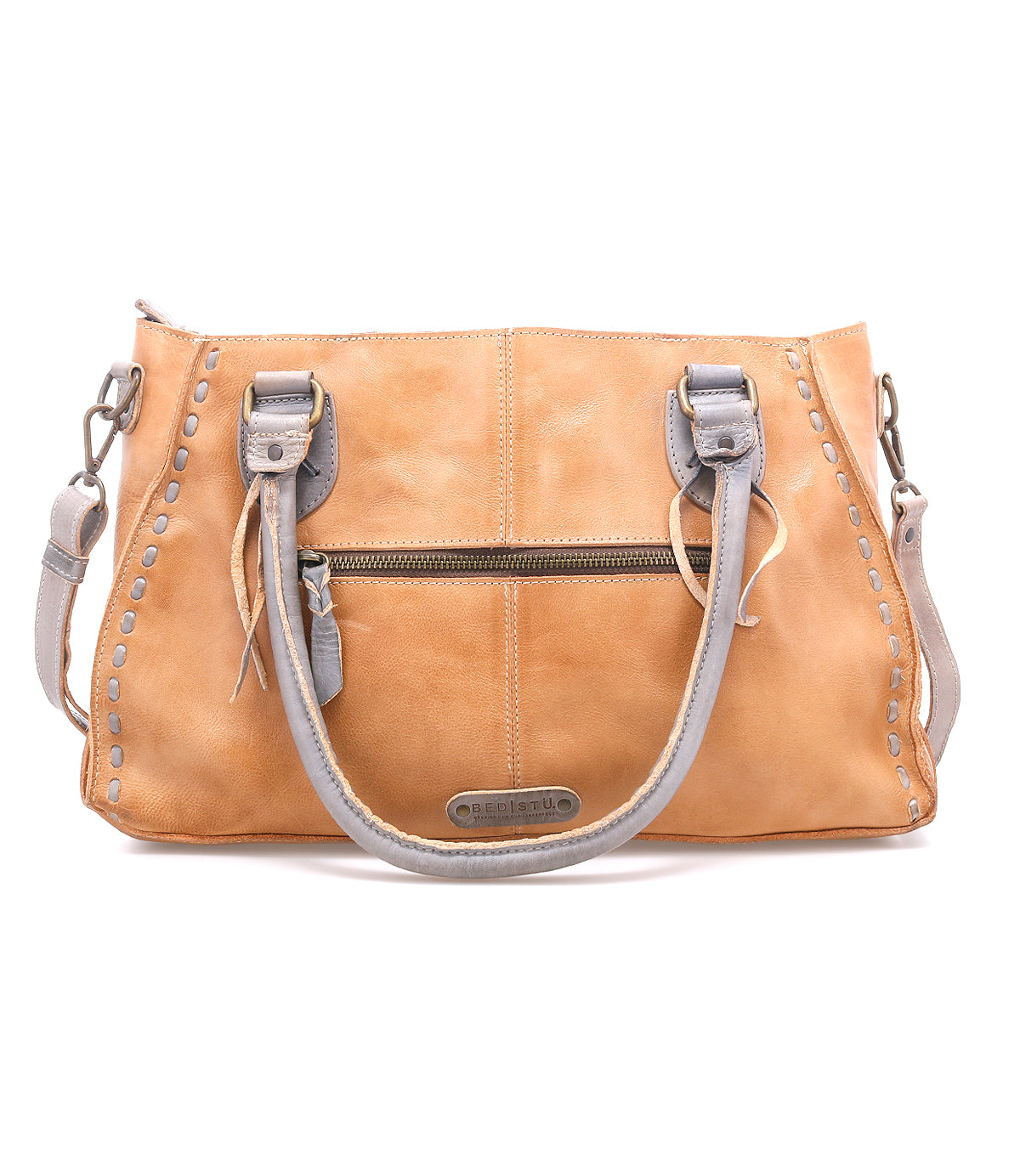 The Bed Stu Rockababy is a tan leather handbag featuring gray handles, a front zipper pocket, decorative stitching, metal brand plate at the bottom center, and a crossbody strap—perfect as a compact everyday bag.