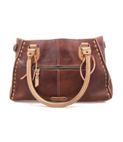 The Bed Stu Rockababy is a compact brown leather handbag with tan handles, an adjustable crossbody strap, front zipper pocket, decorative stitching, and a small brand label—ideal for your daily essentials.