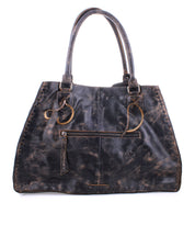 The "Rockaway" by Bed Stu is a distressed black leather handbag featuring long handles, a shoulder strap, a front zip-pocket divider, and a weathered texture.