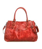 The Bed Stu Rockaway is a spacious, reddish-brown leather handbag featuring dual handles, side lacing, an adjustable shoulder strap, and a zip-pocket divider for organization.