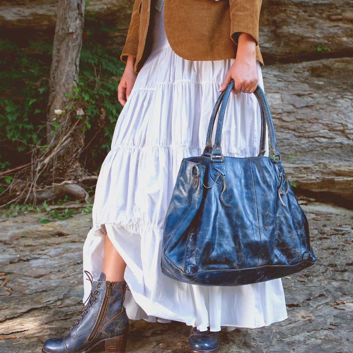 A woman holding a Rockaway bag by Bed Stu.