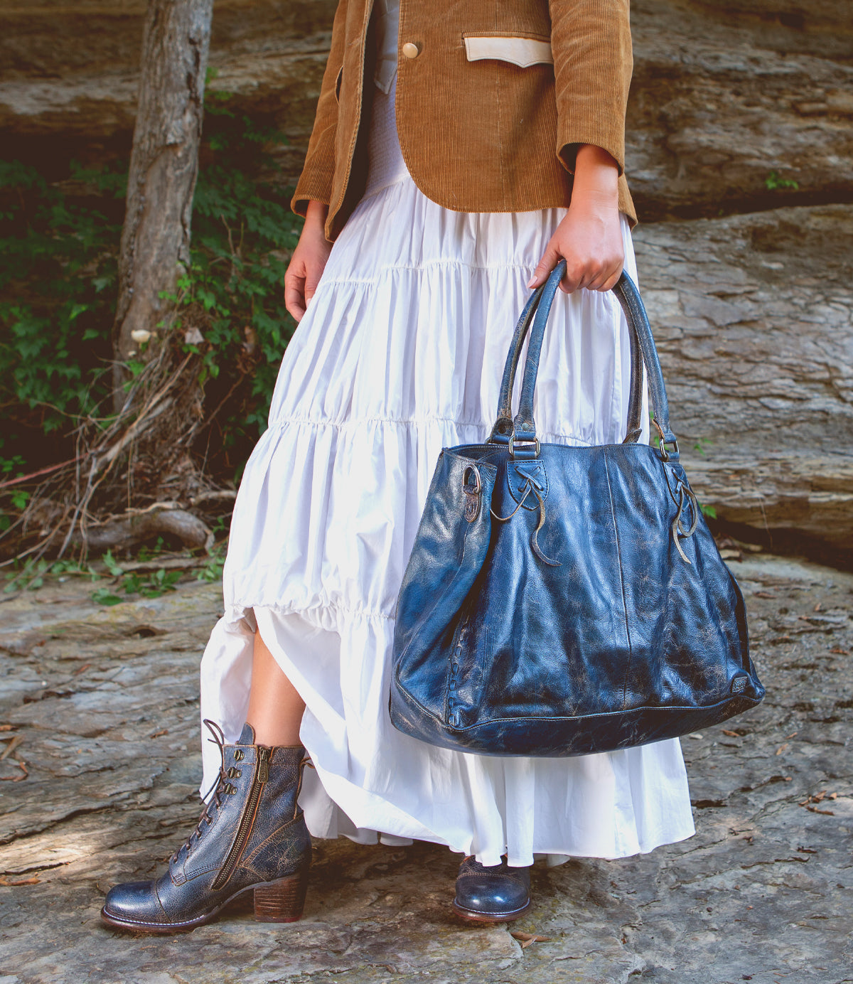 A woman holding a Rockaway bag by Bed Stu.