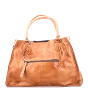 The Rockaway by Bed Stu is a brown leather handbag that features rounded handles and a convenient shoulder strap, enhanced by a front zip-pocket divider for improved organization.