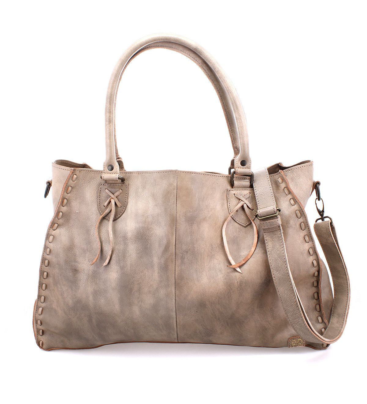 The Rockaway by Bed Stu is a spacious distressed leather bag with decorative stitching, dual handles, a zip-pocket divider, and a detachable shoulder strap.