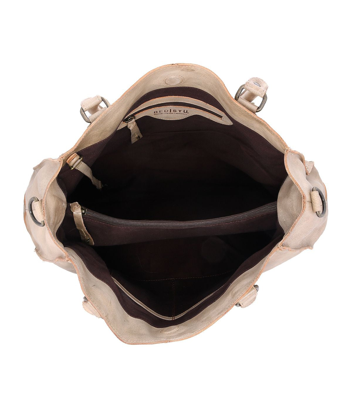 The Rockaway by Bed Stu is an open beige leather bag that includes two compartments and a zip-pocket divider inside, complete with a convenient shoulder strap for easy carrying.