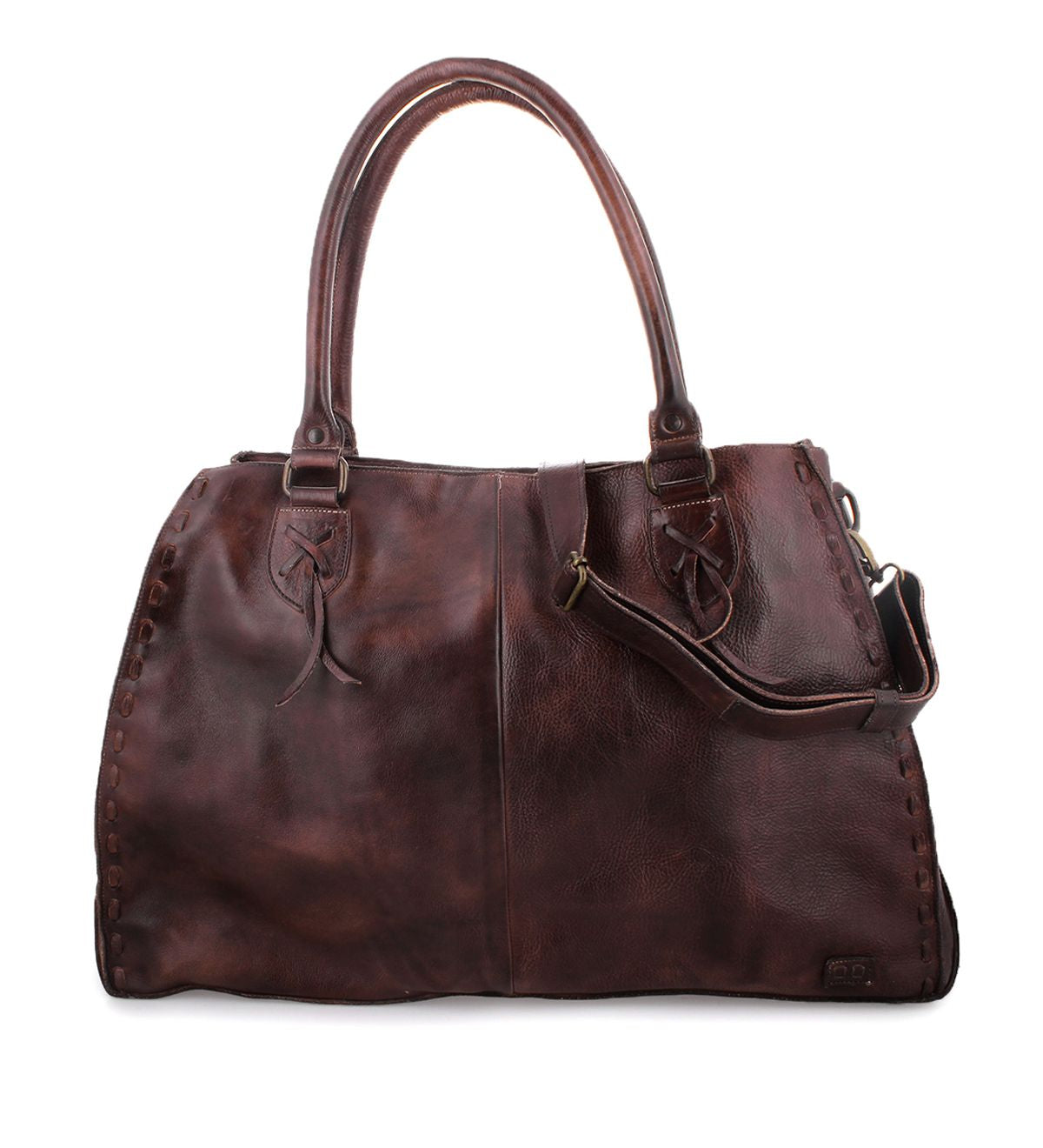 The Rockaway by Bed Stu is a brown leather bag equipped with dual handles, a detachable shoulder strap, and a zip-pocket divider for added convenience.