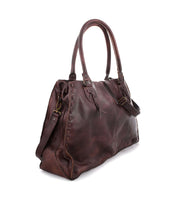 Introducing the Rockaway by Bed Stu: A large, brown leather handbag featuring two handles and intricate stitching details, viewed from the side. Perfect for staying organized while on the go.