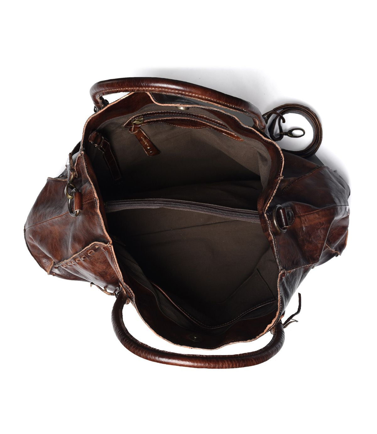 Explore the versatility of our top-selling bag, "Rockaway" by Bed Stu: featuring an open brown leather design with a roomy interior that includes multiple compartments and zipper pockets.