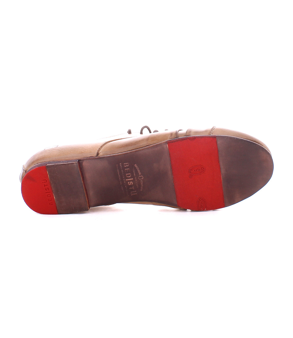 The sole of the Bed Stu Rumba II brown leather dress shoe with red rubber heel and forefoot pads, showing wear marks and branding, combines wingtip flair with sneaker comfort.