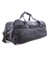 A black leather duffel bag with handles, durable canvas straps, and a zipper closure, featuring an organic cotton lining, Bed Stu's Ruslan.
